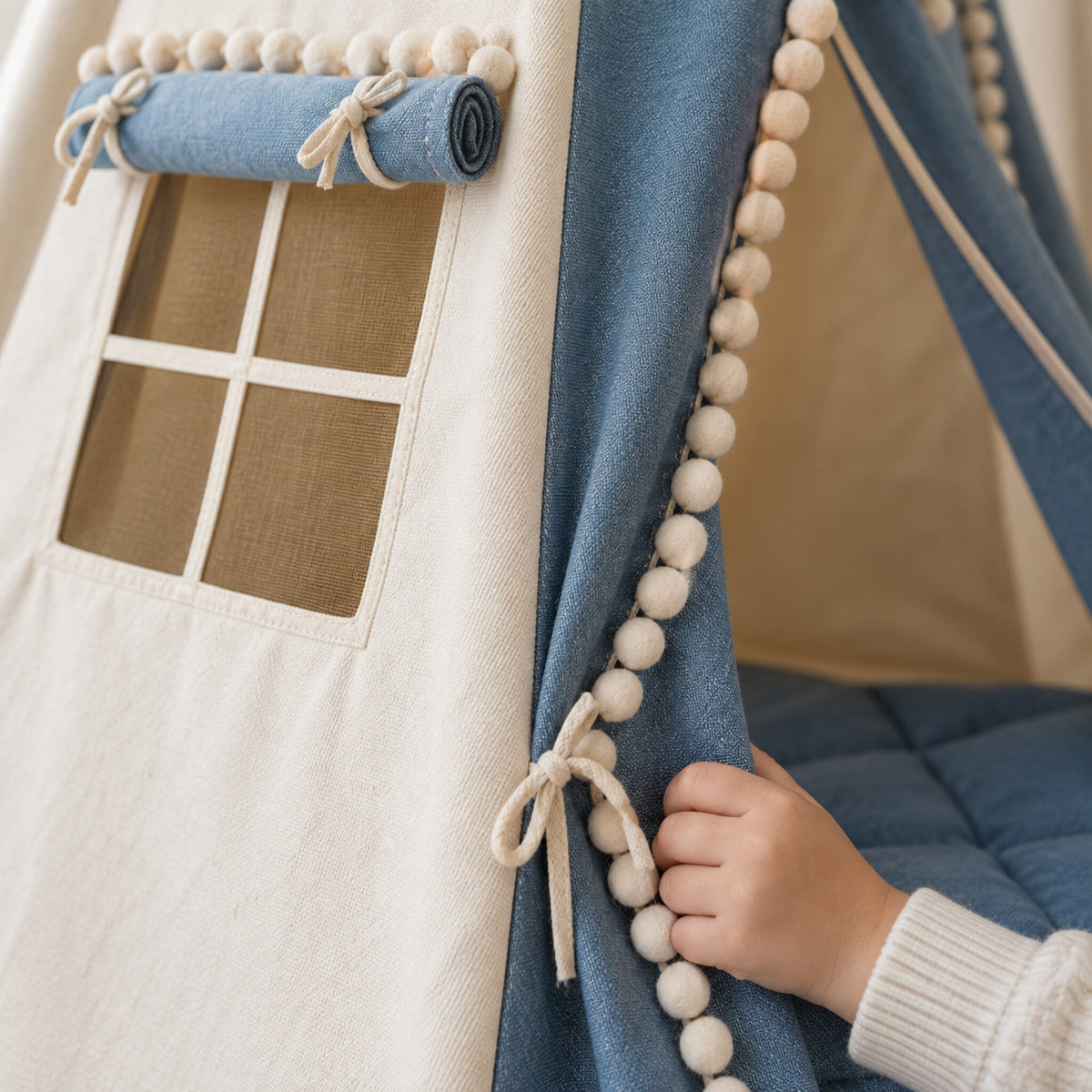 Close-up of the pompom trim on the Denim Pompom kids teepee