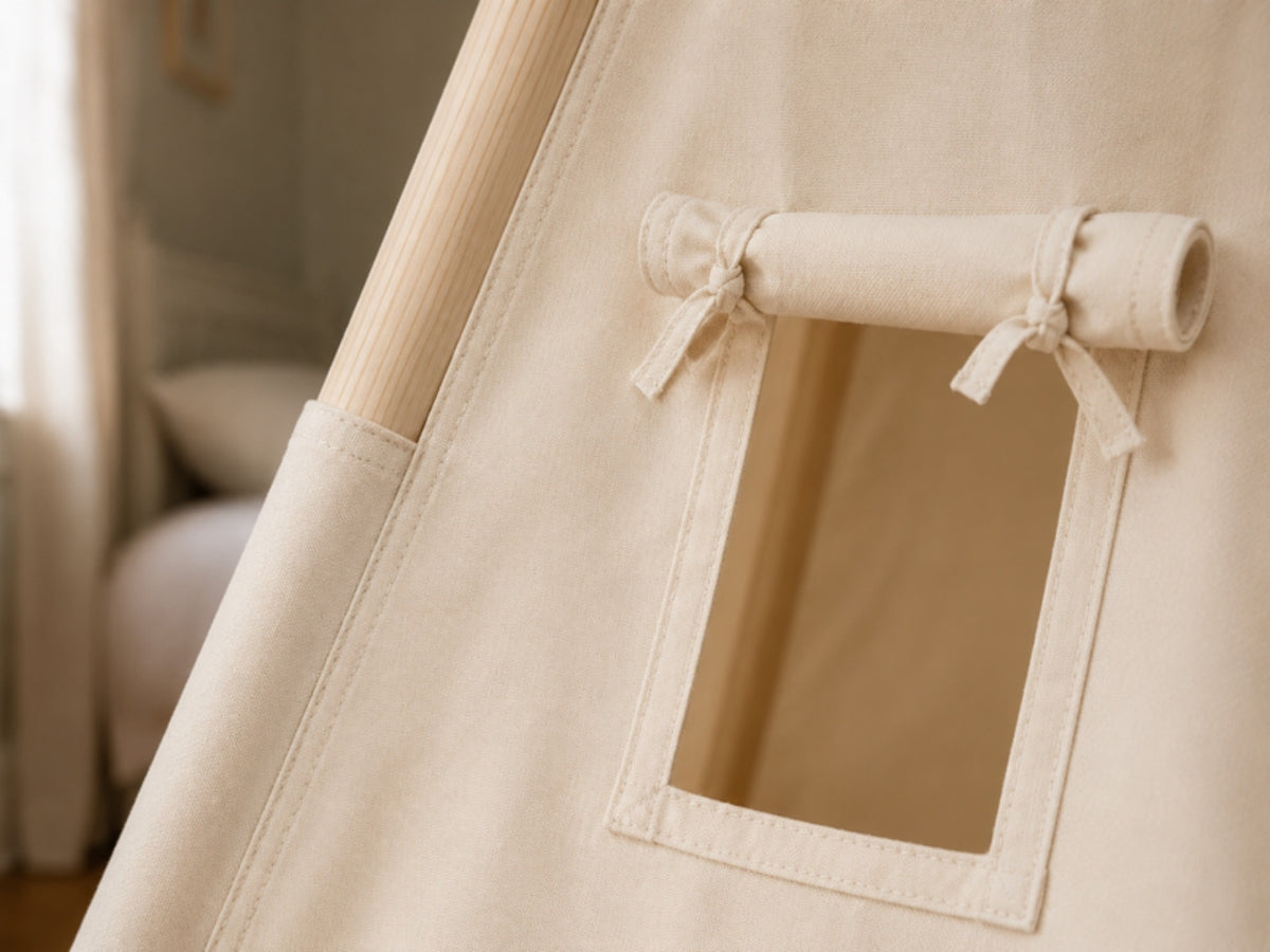 Roll-up canvas window with fabric ties on a cream kids teepee