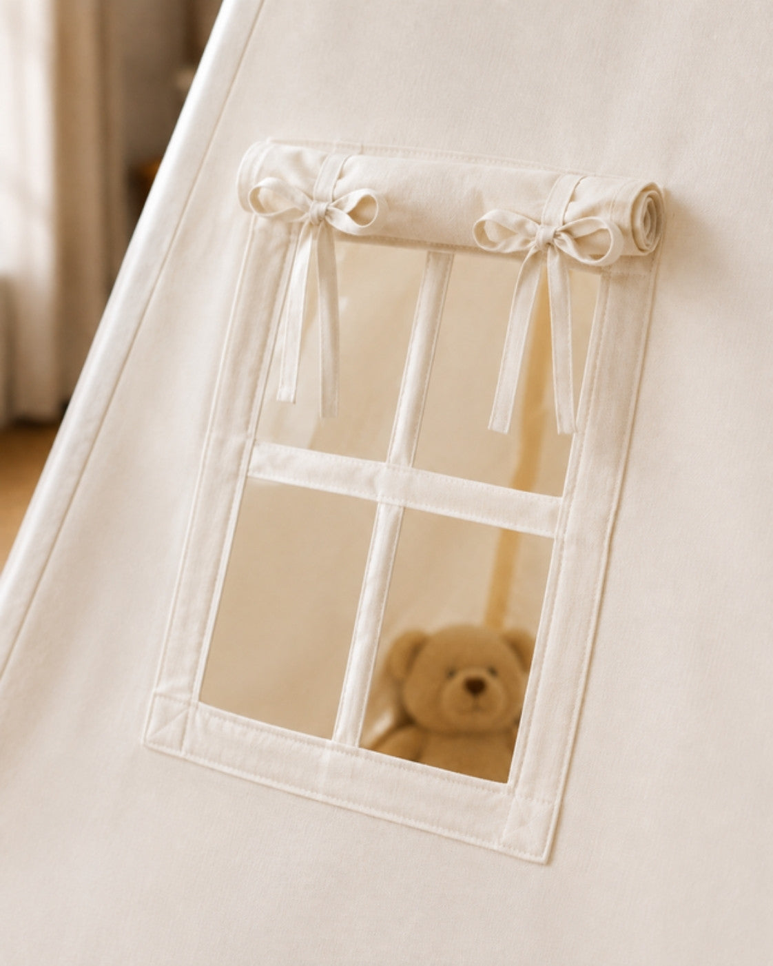 Canvas window detail with fabric ties, teddy inside