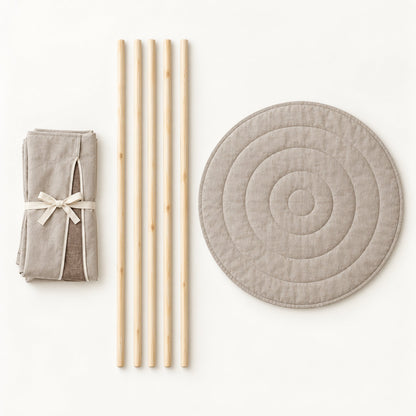 What comes in the box: folded linen, five pine poles and the round padded mat