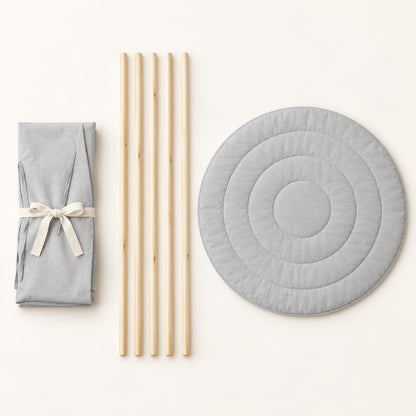 What comes in the box: folded linen, five pine poles and the round padded mat