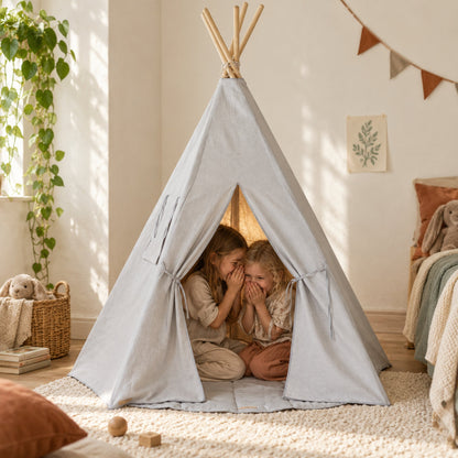 Two children sharing a secret inside the Pigeon Grey Linen kids teepee